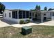 Bright home exterior featuring a carport, screened-in porch, and well-kept lawn at 816 Polo Park East Blvd, Davenport, FL 33897