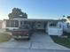 Charming single-story home with covered parking and decorative landscaping at 816 Polo Park East Blvd, Davenport, FL 33897