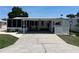 Charming single-story home with covered parking and well-maintained landscaping and beautiful blue skies at 816 Polo Park East Blvd, Davenport, FL 33897
