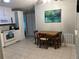 Bright kitchen featuring white cabinetry, a dining table, and tile floors at 816 Polo Park East Blvd, Davenport, FL 33897