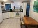 Functional kitchen with ample cabinet space, white appliances, and tiled flooring at 816 Polo Park East Blvd, Davenport, FL 33897