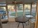 Enclosed lanai featuring tiled floors, a ceiling fan, and several tables, creating a cozy and versatile space at 816 Polo Park East Blvd, Davenport, FL 33897
