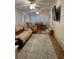 Bright and inviting living room featuring hardwood floors, cozy furniture, and access to the dining area at 816 Polo Park East Blvd, Davenport, FL 33897