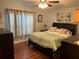 Inviting main bedroom showcasing a comfortable queen bed, warm lighting, and stylish decor at 816 Polo Park East Blvd, Davenport, FL 33897