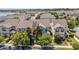An aerial view shows a neighborhood with beautiful landscaping and a nearby lake at 8160 Iron Mountain Trl, Windermere, FL 34786
