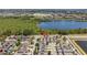 A beautiful aerial view of the neighborhood showing multiple homes and a larger lake at 8160 Iron Mountain Trl, Windermere, FL 34786