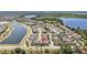 Beautiful aerial view of a community with houses, a lake, and a nearby wooded area at 8160 Iron Mountain Trl, Windermere, FL 34786