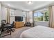 A spacious bedroom with large windows, modern furniture, and a functional workspace at 8160 Iron Mountain Trl, Windermere, FL 34786