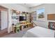 A bedroom featuring a study area with storage, playful decorations, and a window providing natural light at 8160 Iron Mountain Trl, Windermere, FL 34786