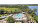 Aerial view of the community pool with a splash pad, plenty of seating and covered areas at 8160 Iron Mountain Trl, Windermere, FL 34786