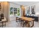 Bright dining room with natural light, contemporary furnishings, and decorative art at 8160 Iron Mountain Trl, Windermere, FL 34786