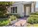 Inviting front porch with brick walkway and lush landscaping, offering a warm welcome at 8160 Iron Mountain Trl, Windermere, FL 34786