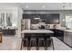 Stylish kitchen with stainless appliances, center island with seating, and dark cabinetry at 8160 Iron Mountain Trl, Windermere, FL 34786