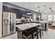 Modern kitchen boasts stainless steel appliances, a center island with seating, and sleek cabinetry at 8160 Iron Mountain Trl, Windermere, FL 34786