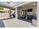 Spacious outdoor patio featuring a ceiling fan, grill area, outdoor furniture, and privacy fencing for relaxation at 8160 Iron Mountain Trl, Windermere, FL 34786