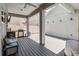 Covered outdoor patio with a grill, seating, and a view of the backyard; an inviting space for outdoor living at 8160 Iron Mountain Trl, Windermere, FL 34786
