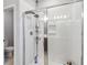 The shower features a glass door, adjustable shower head, and integrated shelving for toiletries and bathroom necessities at 8160 Iron Mountain Trl, Windermere, FL 34786