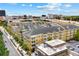 An aerial view of a yellow condo building with a view of downtown in the background at 860 N Orange Ave # 323, Orlando, FL 32801