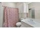 Cozy bathroom featuring a floral shower curtain, a single vanity, and an overhead cabinet for extra storage at 860 N Orange Ave # 323, Orlando, FL 32801