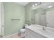 Well-lit bathroom with a single vanity, toilet, and tub/shower combination, featuring light green walls at 860 N Orange Ave # 323, Orlando, FL 32801