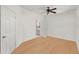 Bright bedroom featuring wood floors and a doorway leading to a bathroom with a vanity and shower at 860 N Orange Ave # 323, Orlando, FL 32801