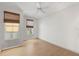 Spacious bedroom with hardwood floors and large windows with woven shades, offering plenty of natural light at 860 N Orange Ave # 323, Orlando, FL 32801