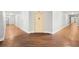Hallway with hardwood floors leading to apartment door, complete with exit signs and doors at 860 N Orange Ave # 323, Orlando, FL 32801