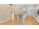 Kitchen with white cabinets, white appliances, a kitchen island, and light hardwood floors at 860 N Orange Ave # 323, Orlando, FL 32801