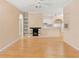 Bright living room features a fireplace, hardwood floors, ceiling fan, and seamless access to the kitchen area at 860 N Orange Ave # 323, Orlando, FL 32801