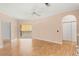 Open-concept living room boasts hardwood floors, a ceiling fan, and balcony access at 860 N Orange Ave # 323, Orlando, FL 32801