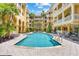 Resort-style pool surrounded by beautiful landscaping and lounge chairs at this yellow apartment building at 860 N Orange Ave # 323, Orlando, FL 32801