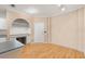 Bright room with light hardwood floors, an arched alcove with shelves, and a built in beverage cooler at 860 N Orange Ave # 323, Orlando, FL 32801