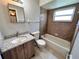 Bright bathroom features a granite countertop vanity and shower-tub combo with neutral tile at 9831 Barley Club Dr # 8, Orlando, FL 32837