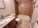 Well-lit bathroom features a granite countertop vanity and shower-tub combo with tiled walls at 9831 Barley Club Dr # 8, Orlando, FL 32837