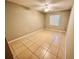 This spacious bedroom is carpet-free, with a ceiling fan, natural light, and neutral paint at 9831 Barley Club Dr # 8, Orlando, FL 32837