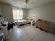 Bedroom with light tile floor and natural light from the window at 9831 Barley Club Dr # 8, Orlando, FL 32837