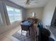This dining room is equipped with a dining table with seating for four and a large window at 9831 Barley Club Dr # 8, Orlando, FL 32837