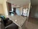 Open kitchen with a breakfast bar, granite counters, wood cabinets, and stainless steel appliances at 9831 Barley Club Dr # 8, Orlando, FL 32837