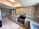 Spacious kitchen with stainless steel appliances, granite counters, and a breakfast bar with tile floors at 9831 Barley Club Dr # 8, Orlando, FL 32837
