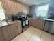 Bright kitchen features granite counters, stainless steel appliances, and wood-grain cabinetry at 9831 Barley Club Dr # 8, Orlando, FL 32837