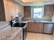 Modern kitchen featuring granite countertops, stainless steel appliances, and light wood cabinets at 9831 Barley Club Dr # 8, Orlando, FL 32837