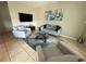 Inviting living room with modern furnishings, including a glass coffee table and neutral color palette at 9831 Barley Club Dr # 8, Orlando, FL 32837