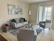 Cozy living room with modern furnishings, a bright window, and a stylish blue accent rug at 9831 Barley Club Dr # 8, Orlando, FL 32837