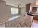 Living space with tile floors, ceiling fan, and granite countertop overlooking kitchen at 9831 Barley Club Dr # 8, Orlando, FL 32837