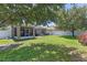 Spacious backyard with lush green grass, a patio, and a white fence at 10138 Lenox St, Clermont, FL 34711