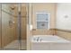 Bathroom featuring a tub, shower and neutral walls at 10138 Lenox St, Clermont, FL 34711