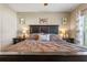 Bedroom featuring a black wood bed frame and side tables with lamps for a cozy atmosphere at 10138 Lenox St, Clermont, FL 34711