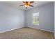 Serene bedroom featuring soft carpeting, natural light, and a neutral color palette at 10138 Lenox St, Clermont, FL 34711