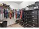 Walk-in closet with rods for hanging clothes, dresser, shelves, and storage solutions at 10138 Lenox St, Clermont, FL 34711