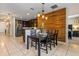 Cozy dining area with wood accent wall, modern lighting, and open to the kitchen, perfect for entertaining at 10138 Lenox St, Clermont, FL 34711